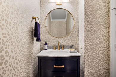 Bathroom with ornamental molding and vanity