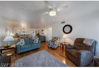 Living area featuring wood finished floors and a c