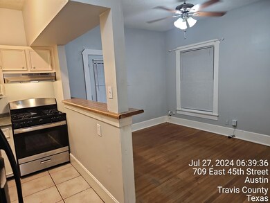 Kitchen with stainless steel range with gas cookt