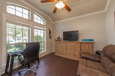 As you enter, the study opens to your left.  It has a raised ceiling with crown molding, ceiling fan and hardwood floors.
