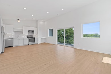 Unfurnished living room featuring a high ceiling,