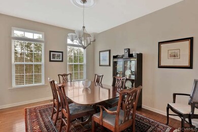 Open Dining Room With Columns And Wood Floors
