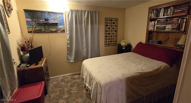 Bedroom featuring dark colored carpet