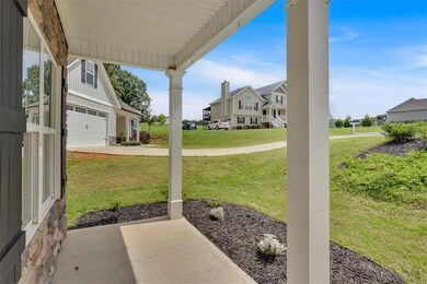 View of patio with a residential view, a garage, and concrete driveway