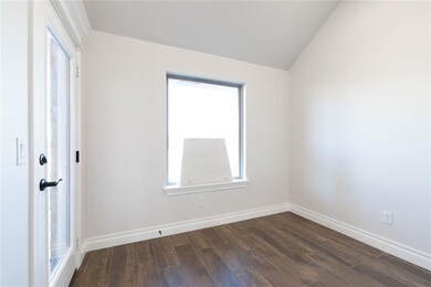 Unfurnished room with lofted ceiling, dark wood-st