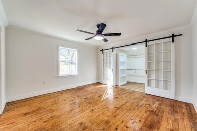 The large primary bedroom includes a custom walk-i