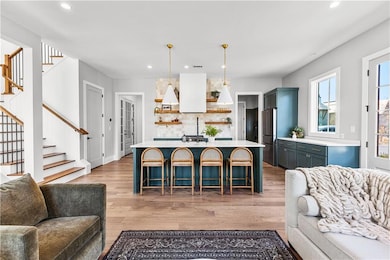 Kitchen featuring open shelves, open floor plan, a