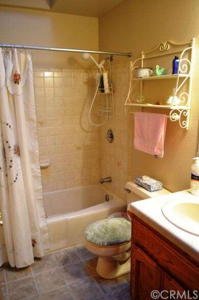 The hall bathroom features a tiled vanity, tub/sho