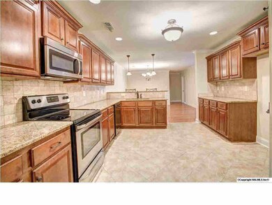 Beautiful kitchen with stainless steel appliances, granite counter tops, and tile flooring