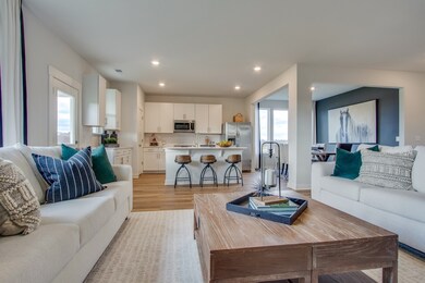 The spacious family room flows seamlessly extends the other main spaces, making it an ideal for entertaining guests with direct access to the outdoor patio for indoor-outdoor living.