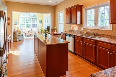 Large kitchen with granite counter tops, tile back