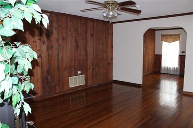 LIVING ROOM: Large living room has beautiful wood 