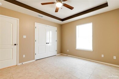 Unfurnished bedroom with ceiling fan, visible vents, baseboards, and light tile patterned flooring
