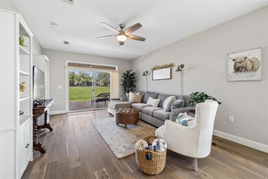 Living area featuring ceiling fan and wood finish