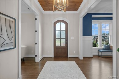 Foyer entrance with dark wood-type flooring, ornam