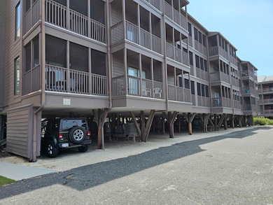 View of apartment building / complex featuring a carport
