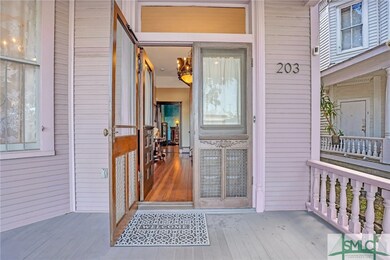 Lovely front porch extends across the front of the