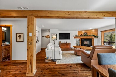 Living room featuring wood finished floors, a glas
