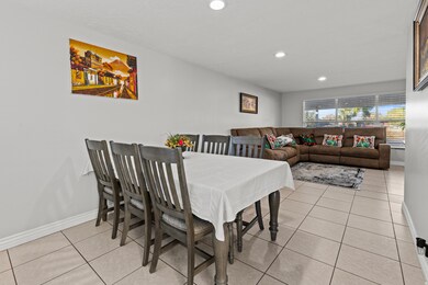 Dining space featuring light tile patterned floors and recessed lighting