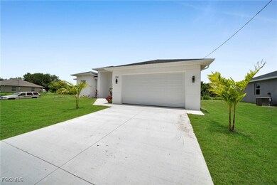 Ranch-style house featuring a front yard, concrete driveway, stucco siding, and an attached garage
