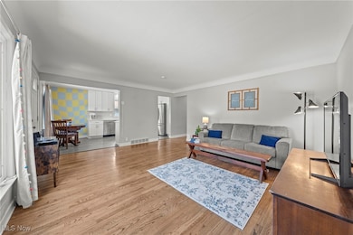 Living room featuring light wood finished floors and baseboards