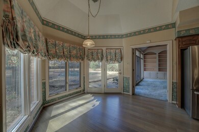The sunny breakfast room overlooks the backyard an