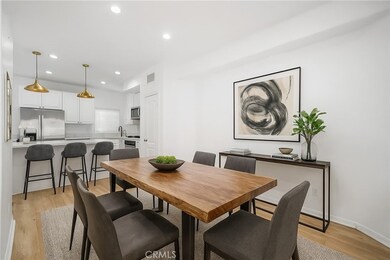 Virtually staged. Kitchen open to space for a dining room table that flows to the living room.
