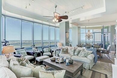 The grand living area has floor-to-ceiling windows
