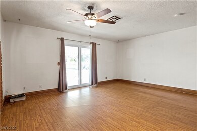 Family room has ceiling fan and sliding doors to p