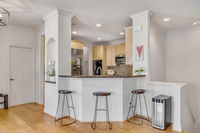 Kitchen with stainless steel appliances, light br