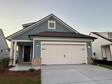 View of front facade featuring a garage and covere