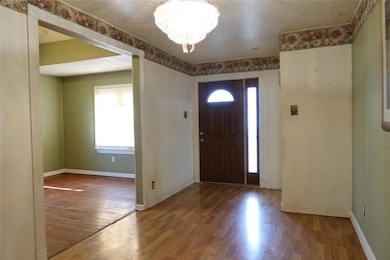 Foyer entrance featuring wood-type flooring, a tex