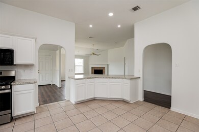 Kitchen boasts tile floor, large island, and open to family room.