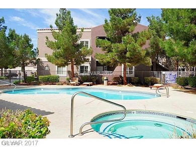 Community pool with a hot tub and a patio area