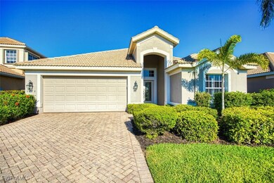 View of front of house featuring a tiled roof, a g