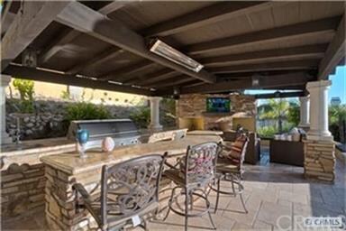 Loggia in back yard next to pool with Lynx BBQ and