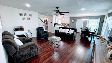This spacious bright living area features rich har