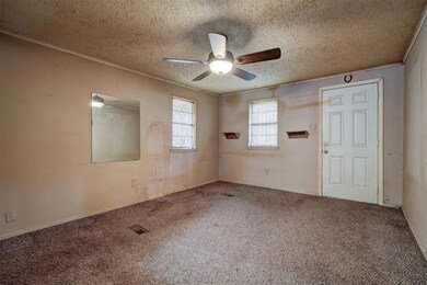 Carpeted empty room with ceiling fan, crown moldin