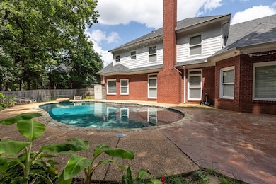 View of swimming pool with a patio and a fenced backyard
