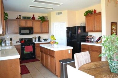 A chefs kitchen with center island and lots of sto