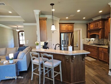 Kitchen with hanging light fixtures, dark wood-typ