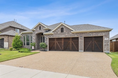 View of front of property with a garage and a front yard