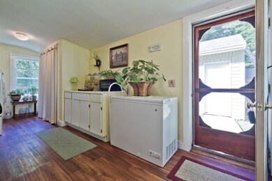 Charming enclosed porch acts as the...