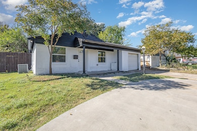 View of front of home featuring a porch, a garage, concrete driveway, and concrete block siding