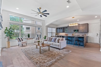 Living room featuring visible vents, recessed lig