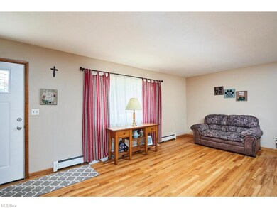 Enter into a spacious living room with hardwood fl