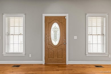 Entrance foyer featuring baseboards, wood finished
