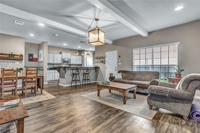 Living room featuring baseboards, dark luxury viny