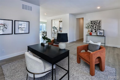 Living room with wood finished floors and recessed lighting