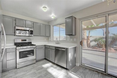 Sunny kitchen with garden window, stainless steel